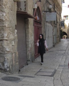 A girl hurries through the Jewish Quarter.