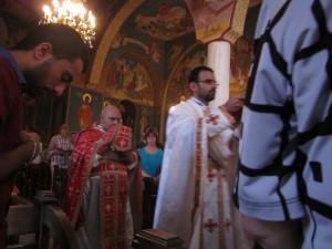 The principal celebrant in red brought the bread and wine to the altar.