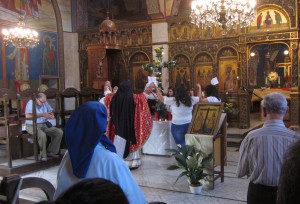 The celebrant reverenced the flowered cross.