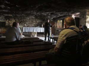 Guide Elias Ghareeb explains how shepherds would often shelter their flocks in a cave.