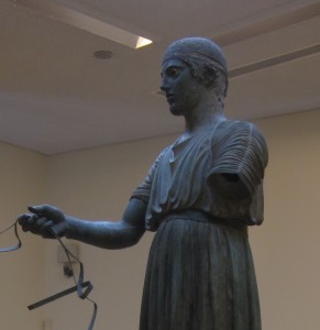 The charioteer's face reveals the Greek ideal.