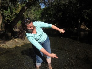 Janelle Neubauer skips a stone at the Jordan's source.