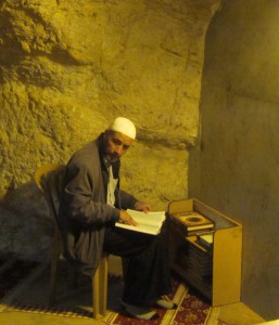 A man prays in the grotto.