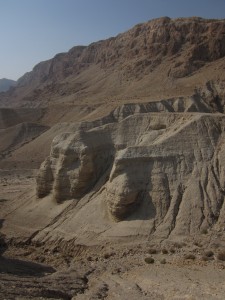 Cliffs loom over Qumran.